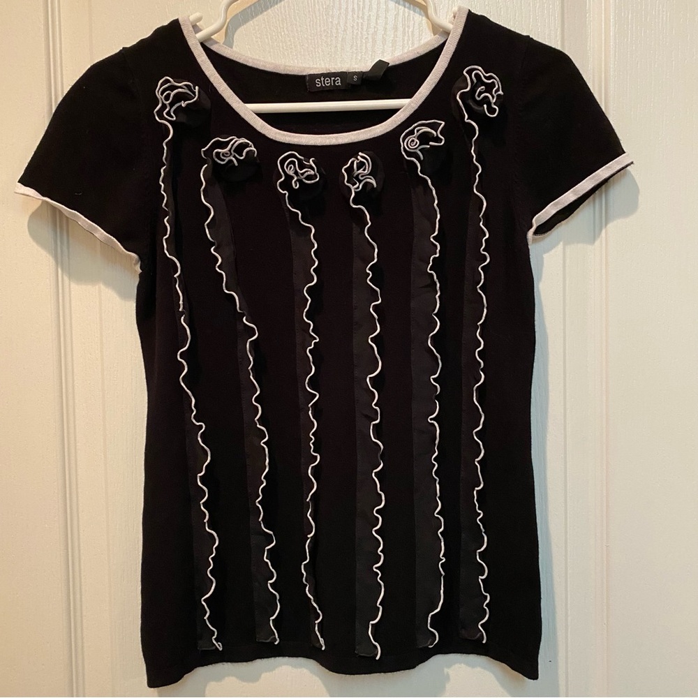 Striking Stera Black And White Sweater with Lace Rosette Vertical Ruffles